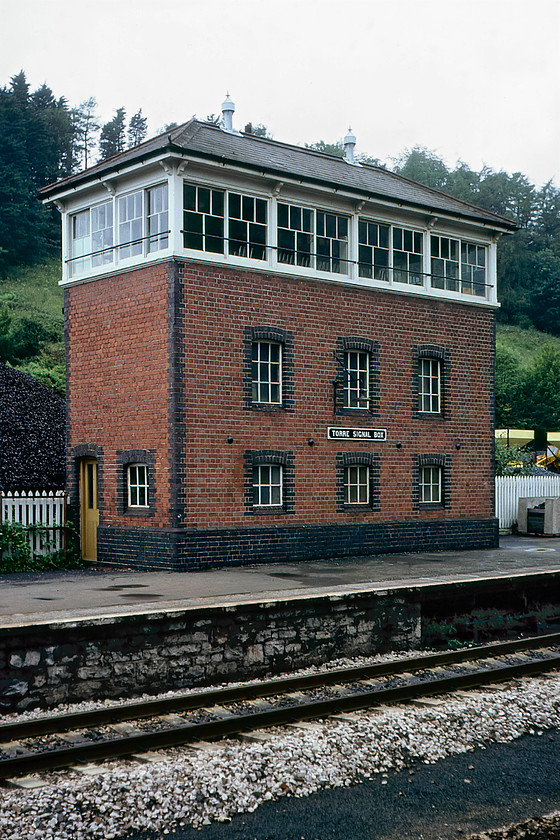 Torre Signal Box (GW, 1921) 
 The impressively tall Torre signal box was constructed by the Great Western Railway in 1921 to their type 7 design and stands on the up platform. Like its smaller brother box a short distance away at Torquay it is still in existence and was to be sold at auction in 2017 but can find nothing out about what has happened since then. Back in 1980 it was still in use but switched out on this particular Sunday afternoon. Notice the large Western Fuel Company coal depot behind the box. I wonder if the odd bucket of coal was passed over the fence for the use of the signalman when his supplies ran low? 
 Keywords: Torre Signal Box