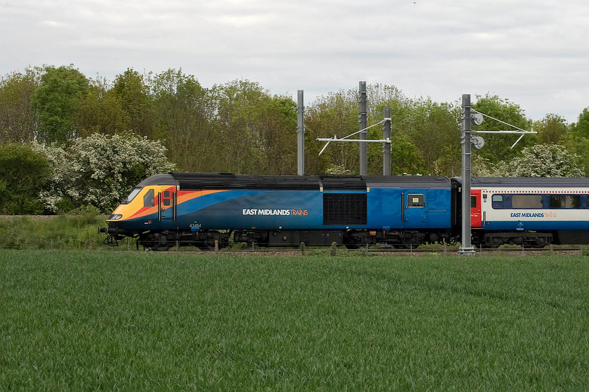 43484, EM 18.37 Corby-London St. Pancras (1P41, 10L), Irchester SP926665 
 43484 brings up the rear of the 18.37 Corby to London St. Pancras HST working. It is seen passing Irchester having just made its Wellingborough stop. On a dull spring evening in a rather monotonous green environment, the revised East Midlands Trains livery stands out rather well. Notice that this power car has buffer beams fitted indicating that it was one of the fourteen selected to work on the ECML as surrogate DVTs prior to the full introduction of the class 82 DVTs way back in 1987. When they were dispensed with the control equipment was removed but the buffer beams remained. 
 Keywords: 43484 18.37 Corby-London St. Pancras 1P41 Irchester SP926665