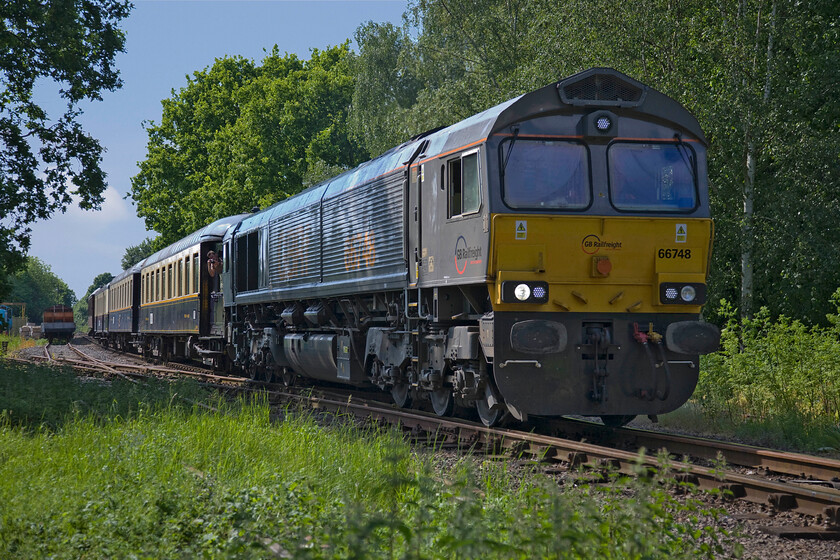 66748, 15.12 Yarwell Junction-Peterborough NV (2E53), Ferry Meadows TL153970 
 66748 leaves Ferry Meadows station working the 15.12 Yarwell Junction to Peterborough Nene Valley. This visiting Class 66 has been in the country for just seventeen months having been delivered new to Dutch railways some years earlier. It still wears its European all-over plain grey paintwork but with orange GBRf branding and large numbers applied to the bodysides. 
 Keywords: 66748 15.12 Yarwell Junction-Peterborough Nene Valley 2E53 Ferry Meadows TL153970 GBRF