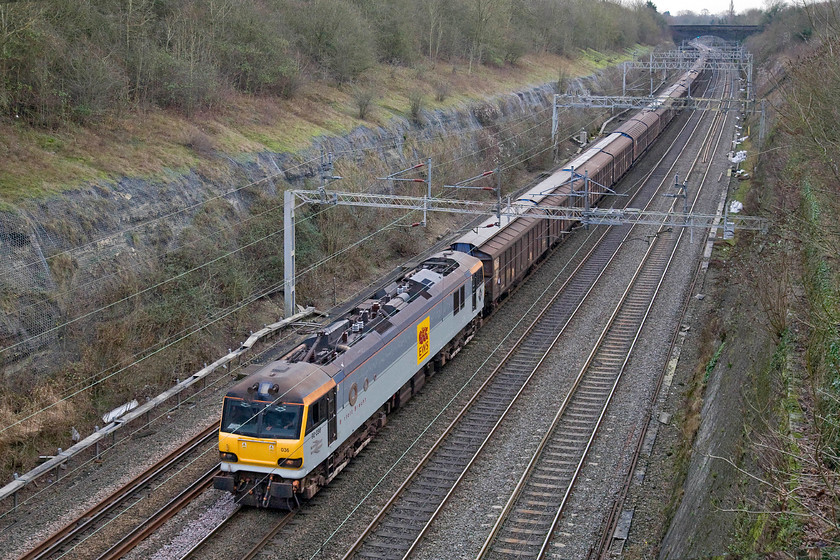 92036, 11.47 Wembley-DIRFT (0B41), Roade cutting 
 92036 'Bertolt Brecht' leads the 0B41 11.47 Wembley to Daventry bottled water train through Roade cutting in the fading afternoon light. This train will have originated from Dollands Moor having come through the tunnel from France last night. This is an ageing two-tone Railfreight grey livery now being the one that the Class 92 will have left Brush at Loughborough in October 1995 and note that it is still wearing its BR raised arrow some eighteen years after the nationalised company ceased to exist! 
 Keywords: 92036 11.47 Wembley-DIRFT 0B41 Roade cutting Bertolt Brecht