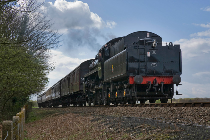 76034 (76084) 15.45 Holt-Sheringham, Kelling bank TG114419 
 Class 4MT 76084 (running as 76034) gingerly descends Kelling bank on the approach to Weybourne. It is leading the 15.45 Holt to Sheringham North Norfolk Railway service. The photograph is taken over the fence from a footpath that follows the line for some distance between Weybourne and Kelling. 
 Keywords: 76034 15.45 Holt-Sheringham Kelling bank TG114419 British Railways Standard Class 4MT 76084