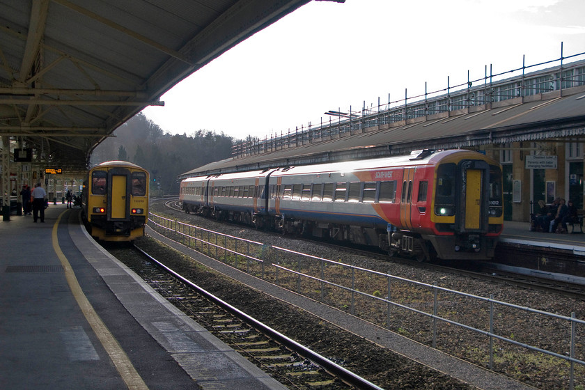 150246, GW 15.28 Warminster-Great Malvern (2E25) & 159012, SW 15.51 Bristol Temple Meads-London Waterloo (1O60), Bath Spa station 
 150246 pauses at Bath Spa station with the 15.28 Warminster to Great Malvern service whilst South West Trains' 159246 gets away with the 15.51 Bristol Temple Meads to London Waterloo train. Notice the wide gap between the up and down lines that, until 1967 accommodated a pair of passing loops that were also linked allowing the transfer of trains from track to track. All was controlled from the lofty signal box located above the canopy on the down platform approximately above where I am standing to take this photograph. 
 Keywords: 150246 15.28 Warminster-Great Malvern 2E25 159012 15.51 Bristol Temple Meads-London Waterloo 1O60 Bath Spa station First Great Western South West Trains