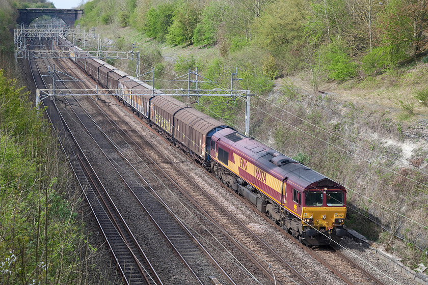 66024, 14.47 Daventry-Dollands Moor (6M45), Hyde Road bridge 
 66024 brings the daily 14.47 Daventry to Dollands Moor empty cargowagons 6M45 working through Roade Cutting. The picture is taken from Hyde Road bridge in the village just yards from my doctor's surgery. As the train was running a few minutes late I just had time to dash into reception and meet my appointment time! 
 Keywords: 66024 14.47 Daventry-Dollands Moor 6M45 Hyde Road bridge