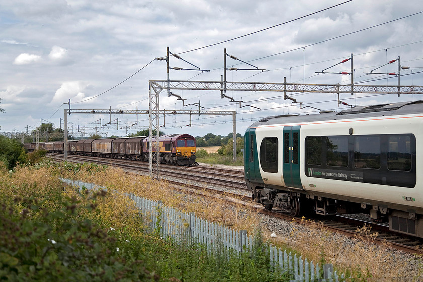 66013, 14.47 DIRFT-Dollands Moor (6M45, 5L) & 350239, LN 14.46 London Euston-Crewe (1U39, 1L), Gordon's Lodge 
 Bowled by a Desiro! 350239 forming the 14.46 Euston to Crewe passes me at Gordon's Lodge on the down fast line spoiling my opportunity to capture a decent photograph of the 6M45. The 14.47 Daventry to Dollands Moor empty bottled water train is being led by EWS liveried 66013. The two trains are passing at Gordon's Lodge just a short distance north of Hanslope Junction. 
 Keywords: 66013 14.47 DIRFT-Dollands Moor 6M45 350239 14.46 London Euston-Crewe 1U39Gordon's Lodge Desiro London NorthWestern