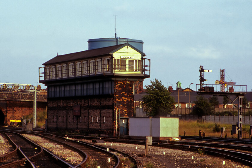 Chester No.2 signal box. jpg 
 The fantastic LNWR Chester No. 2 signal box was a dominant feature at the eastern end of Chester General station until its demise at the start of May 1984. Carrying its LNWR nameboard (post-1935) it also carries a huge British Railways (Midland) enamel with a matching example on the other side pointing to Chester station with a large double-tailed arrow. Number 1 signal box was a British Railways Type 15 box just a short distance from this box under the bridge to the extreme left. It's a shame that my photograph of the box is of such poor quality as it is the only one in my archive of this fine structure. 
 Keywords: Chester No.2 signal box Number 2 no2