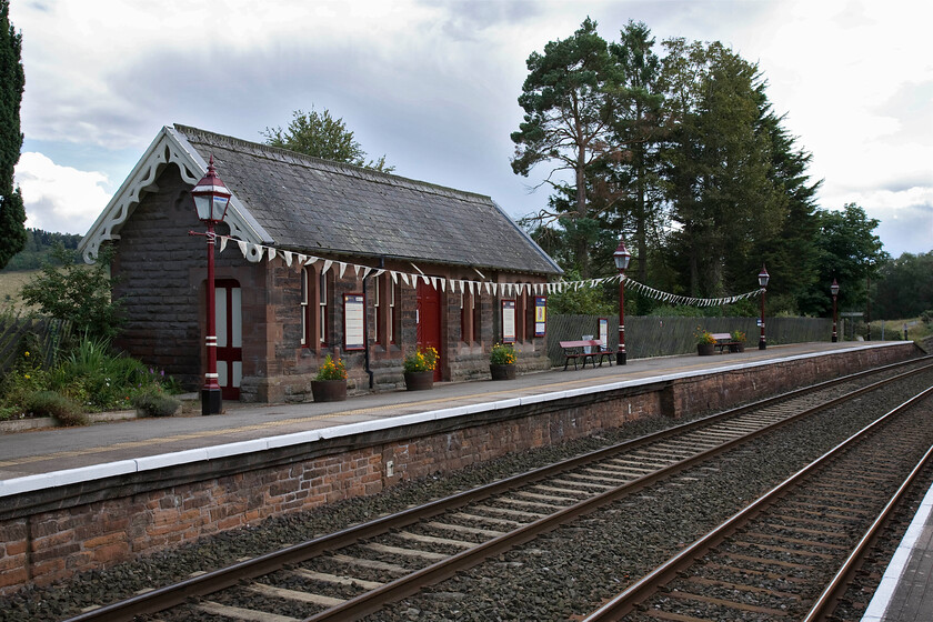 Armathwaite station 
 Like virtually all the other stations the length of the Settle and Carlisle route Armathwaite was closed in 1970 as part of BR's managed rundown of the entire route. However, the line was reprieved and now flourishes with stations such as this reopened in 1986. The waiting room on the southbound platform looks well maintained enhanced by the bunting draped between the lamp standards. The main building on the down platform is now a private residence. 
 Keywords: Armathwaite station