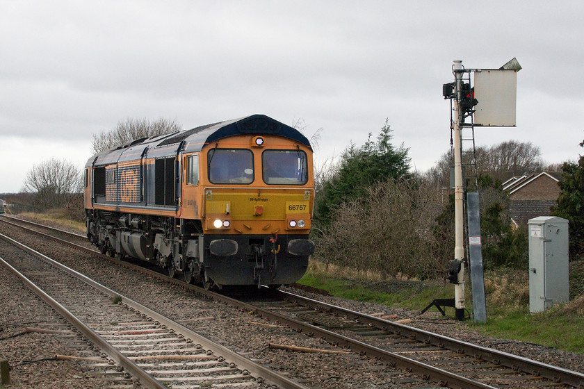 66757, 10.49 Peterborough Maintenance Shed-Ferme Park LE, Whittlesea level crossing 
 66757 'West Somerset Railway' passes Whittlesea as the 10.49 Peterborough Maintenance shed to Ferme Park light engine move. This would normally have nipped down the ECML but was diverted across to the Great Eastern due to engineering works. Ironically, as I was digitally processing this actual image the evening after I took this picture, 66757 worked past my house in Roade on the WCML with a Ferme Park to Hams Hall empty Freightliner flats train that it had been sent south to collect. 
 Keywords: 66757 10.49 Peterborough Maintenance Shed-Ferme Park Whittlesea level crossing