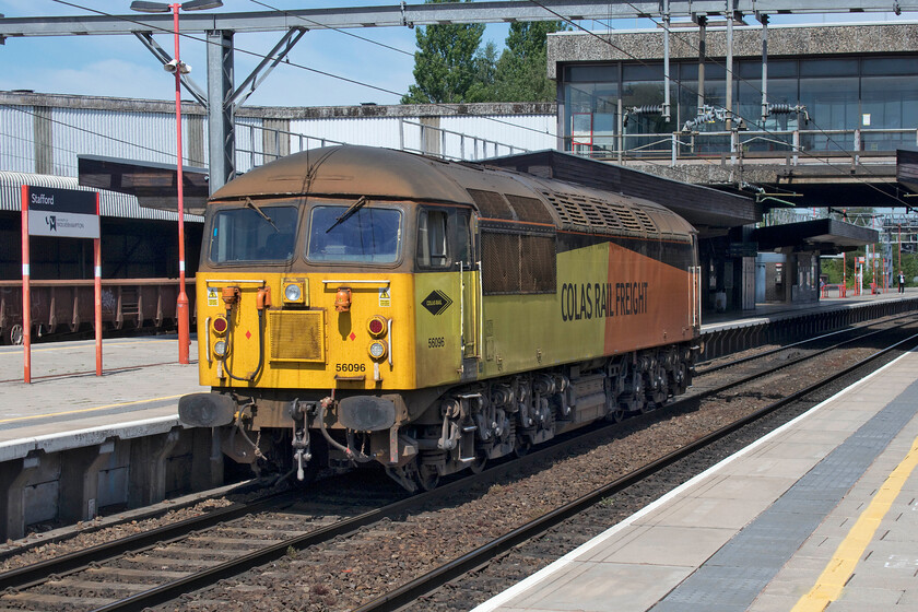 56096, running round, Stafford station 
 Having arrived with the 6K38 Longport to Basford Hall freight composed of infrastructure wagons 56096 is seen running round its train, that can be seen in the background, at Stafford. The rather convoluted route was necessitated by the Longport facility to the south of Stoke-on-Trent having no north-facing access to the mainline that would have enabled a relatively easy trip to Crewe via the Alsager route 
 Keywords: 56096 running round Stafford station Colas