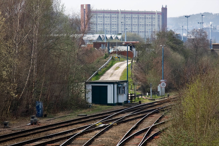 Woodburn Junction signal box (BR, 1992) 
 There was once a superb Great Central signal box at Woodburn Junction but on its closure in 1992, this porta-cabin structure was deemed as a worthy replacement by BR! In recent years, the new structure has had a cosmetic facelift after it became daubed with graffiti. It contains a mini panel that controls the immediate area and the lines to Rotherham and the closed Tinsley yard that branches off in the foreground. This route to Rotherham has now been singled but can still see occasional use as a usful diversionallry route from the Midland route north of Sheffield. 
 Keywords: Woodburn Junction signal box