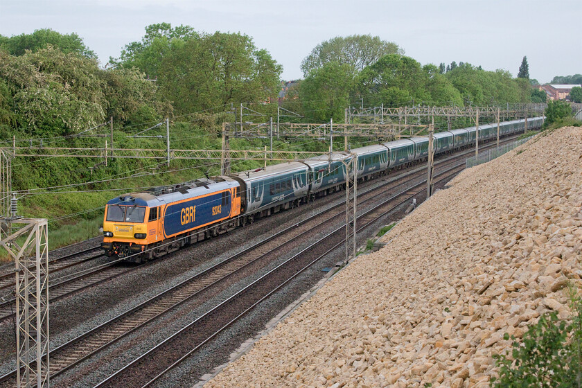 92043, CS 20.45 Inverness & 21.45 Aberdeen-London Euston (1M16, 1E), Ashton Road bridge 
 92043 brightens up a rather grey spring morning as it passes Roade, taken from Ashton Road bridge, leading the 1M16 sleeper. I would have been unhappy if I had been berthed in the final coach of the consist as one of the wheels had a severe flat that would have been felt and heard within the cabins! 
 Keywords: 92043 20.45 Inverness 21.45 Aberdeen-London Euston 1M16 Ashton Road bridge GBRF Caledonian Sleeper