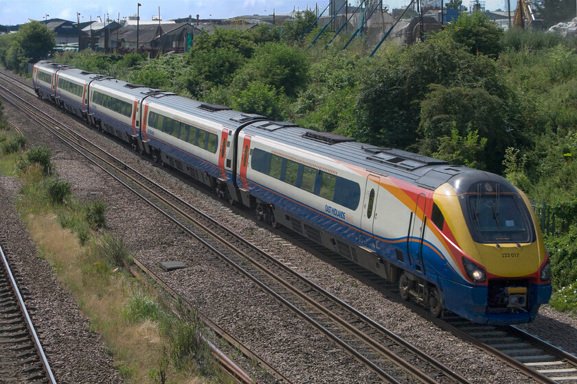 222017, EM 10.26 London St. Pancras-Sheffield (1F23), Finedon Road industrial estate SP900702 
 222017 speeds past Wellingborough's Finedon Road industrial estate working the 10.26 St. Pancras to Sheffield train. This photograph has needed a great deal of work in Photoshop due to the awful and very strong back lighting! 
 Keywords: 222017 10.26 London St. Pancras-Sheffield 1F23 Finedon Road industrial estate SP900702 EMR East Midlands Railway Meridian