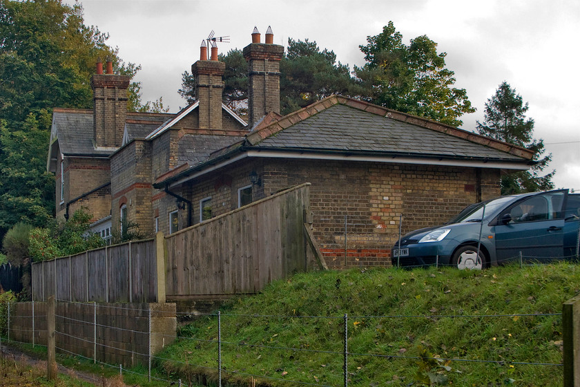 Former Coltishall station 
 The former Coltishall station is seen from the passing Bure Valley narrow gauge service. The building is unmistakably Great Eastern in origin closing to passengers on 15.09.52 along with the rest of the line from Wroxham to County School station that is now part of the Mid Norfolk Railway. The spur to Aylsham lingered on seeing sporadic freight use carrying prefabricated concrete sections delivered by road from the Lenwade factory up until 1982. 
 Keywords: Former Coltishall station