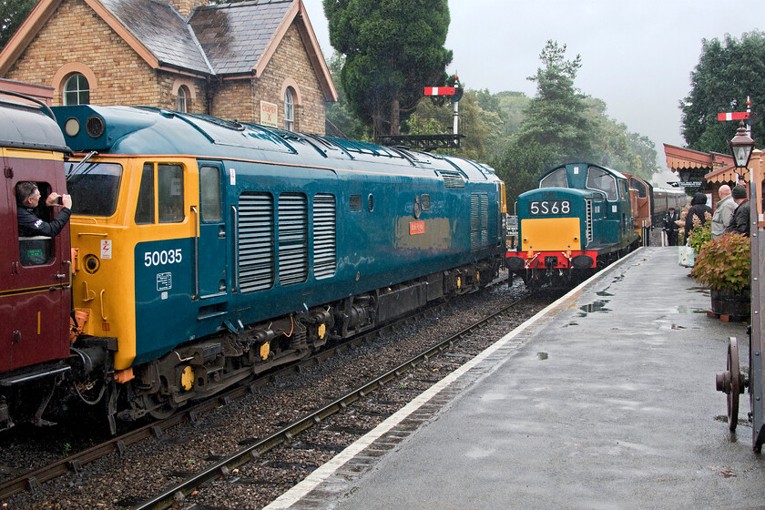 D8568 & D9551, 14.33 Bridgnorth-Kidderminster & 50035, 13.50 Kidderminster-Bridgnorth, Hampton Loade station 
 With a combined one thousand two hundred and fifty horsepower from the Clayton D8568 and Class 14 'Teddy Bear' D9551 there will be no problems getting Andy and me the short hop from Hampton Loade to Highley whilst they double head the 14.33 Bridgnorth to Kidderminster train. In the pouring rain, they arrive at Hampton Loade station while 50035 'Ark Royal' waits to leave with the 13.50 Kidderminster to Bridgnorth service. 
 Keywords: D8568 D9551 14.33 Bridgnorth-Kidderminster 50035 13.50 Kidderminster-Bridgnorth Hampton Loade station Ark Royal Clayton