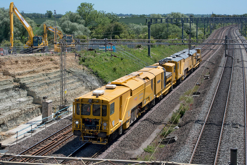 DR80301 & DR80303, 10.00 Woking up yard-Guide Bridge (79L), Ashton Road bridge 
 A pair of Harsco Rail Technologies multi-purpose stoneblowers head north along the down slow line just south of Roade past the closed Amco Giffen worksite. DR80301 'Stephen Cornish' and DR80303 were working as the 10.00 Woking Yard to Guide Bridge, I presume in connection with weekend engineering works. 
 Keywords: DR80301 DR80303 10.00 Woking up yard-Guide Bridge Ashton Road bridge Stephen Cornish Harsco Rail Technologies Multi-purpose stoneblower