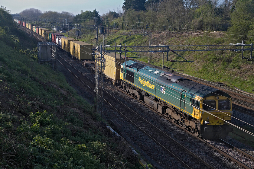 66593, 02.50 Felixstowe North-Garston (4M45, 13E), Victoria bridge 
 The 02.50 Felixstowe to Garston 4M15 Freightliner passes Victoria bridge just south of Roade led by 66593 3MG Mersey Multimodal Gateway. This weekday Freightliner covers just under three hundred miles taking a circuitous route initially south to London before heading northwards to Merseyside. This should be one of the services that ought to travel via the Fens through to Peterborough and Leicester thus saving many miles I would have thought but capacity issues on certain parts of this route remain a problem. 
 Keywords: 66593 02.50 Felixstowe North-Garston 4M45 Victoria bridge Freightliner 3MG Mersey Multimodal Gateway