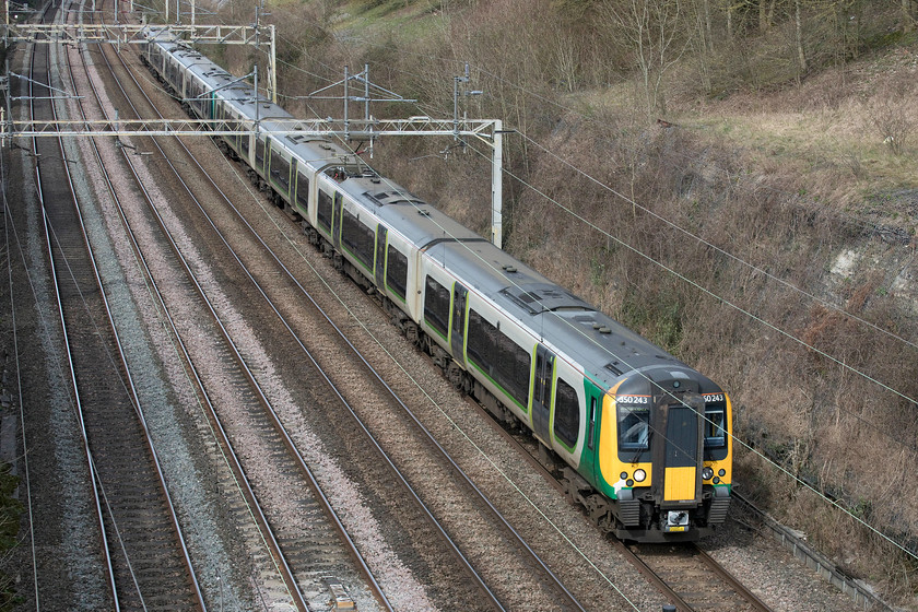 350243 & 350244, LN 10.13 Rugeley Trent valley-London Euston (1Y20, 2L), Hyde Road bridge 
 Looks can be deceiving. Despite the lovely early spring sunshine, it was, in fact, a chilly day with a keen easterly wind blowing! 350243 and 350244 pass through Roade about to go under Hyde Road Bridge with the 1Y20 10.13 Rugeley Trent Valley to Euston service. From the coming Monday, there will be a gradual withdrawal of services in response to the dramatic decline in numbers of passengers as a result of the COVID-19 pandemic. I suspect then over the coming months that there will be what amounts to a skeleton service with an increase in freight services also predicted. 
 Keywords: 350243 350244 10.13 Rugeley Trent valley-London Euston 1Y20 Hyde Road bridge London North Western Desiro