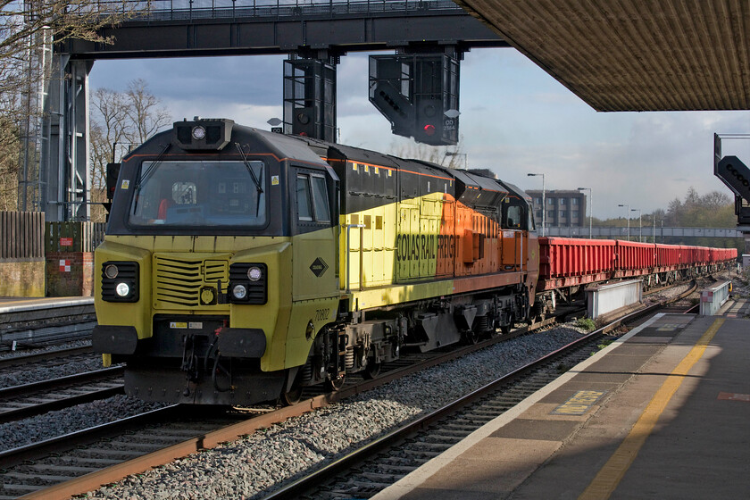 70802, 17.54 Hinksey Yard-Bescot Yard (6M28, 79E), Oxford station 
 Colas operate seventeen Class 70s in the 708XX subset of the class. All are liveried in their distinctive yellow and orange paint scheme. In a welcome burst of late afternoon sunshine at Oxford, belying the fact that it was absolutely perishing, 70802 gets the 17.54 Hinksey Yard to Bescot engineering train away through the station. The driver had been giving it some beans as it approached the southern end of the station thinking that he was off and away but the train was then cautioned and halted to the north of the station; what a frustration that must be for a freight driver eager to get home for his tea! 
 Keywords: 70802 17.54 Hinksey Yard-Bescot Yard 6M28 Oxford station Colas Railfreight