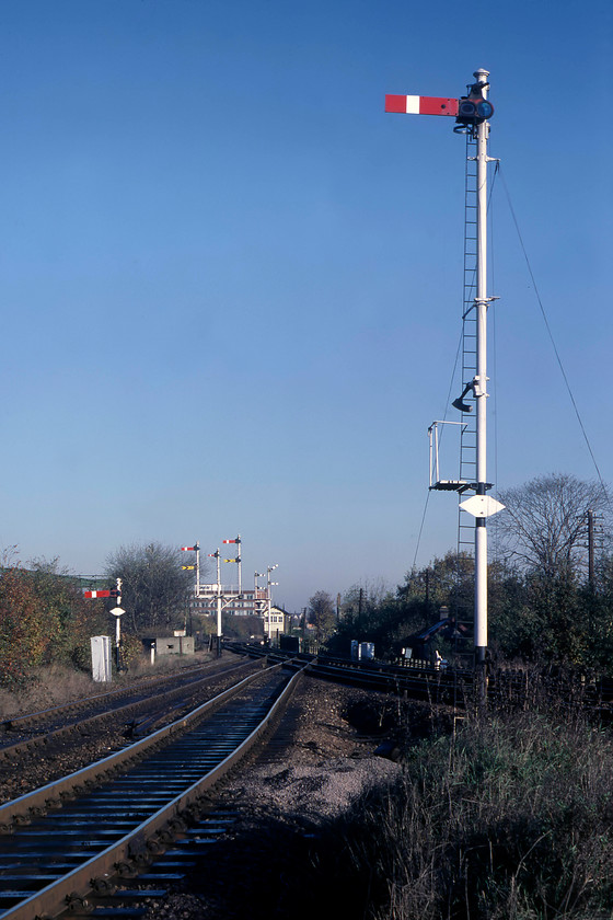 Signals, Acton Wells Junction TQ211817 
 Another example of an extremely tall signal post is seen at Acton Wells. There is also a number of other semaphores in the distance and the North London Acton Wells Junction signal box. The line curving away to my left drops down to the GWML and Acton yard. The line to the right continues south towards South Acton and the Kew triangle. As Acton Wells box was manned, witness the up home signal pulled off, Graham and I had to proceed with care so as to avoid being spotted! 
 Keywords: Signals Acton Wells Junction TQ211817