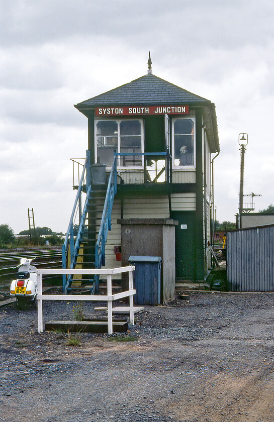 Syston South Junction signal box (MR, 1911) 
 Taken from the southern end Syston South Junction is seen looking remarkably original right down to its finials and windows. The box was a Midland Type 4c design that replaced an earlier 1887 structure on the opposite side of the line. Closure came on 26.08.87 when the signalling from Syston to Loughborough and Frisby passed to the Leicester PSB. Notice the signalman's almost new ('W' registration was 1980/1981) nice and shiny Vespa moped parked up at the bottom of the steps waiting to whisk him home with a haze of two-stroke exhaust following at the end of what would have probably been his two-to-ten shift. 
 Keywords: Syston South Junction signal box MR Midland Railway