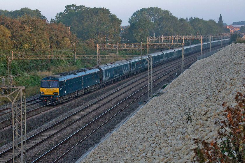 92010, 20.45 Inverness & 19.50 Fort William-London Euston (1M16, RT), Ashton Road bridge 
 Not yet in the early morning sunshine 92010 leads the 1M16 up Highland sleeper past Roade in South Northamptonshire. With Caledonian Sleeper in all sorts of difficulties, it will have been pleased that today the train ran bang on time with arrival into Euston some forty minutes after this photograph was taken. 
 Keywords: 92010 20.45 Inverness 19.50 Fort William-London Euston 1M16 Ashton Road bridge Caledonian Sleeper