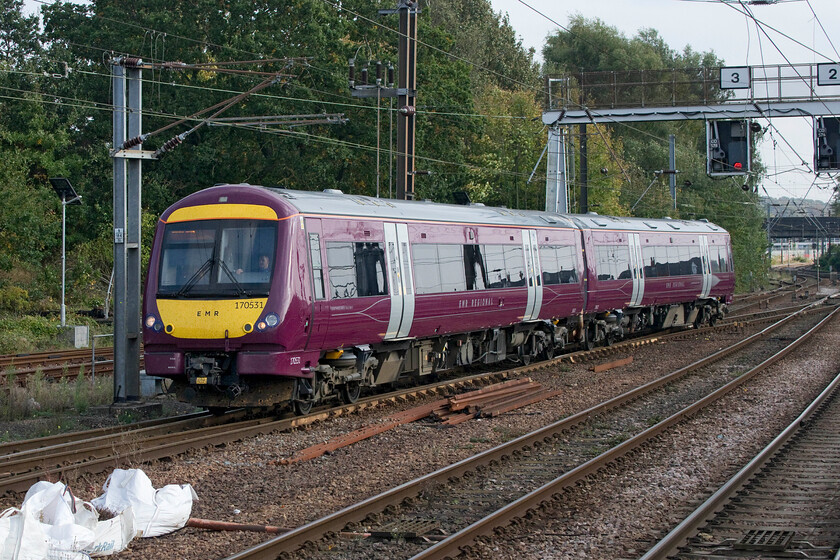 170531, EM 11.40 Nottingham-Norwich (1L08, 9L), Norwich station 
 The shine on 170531 is mirror-like! It is seen approaching Norwich having worked the 11.40 from Nottingham arriving a little late. This member of the class is one of five that were acquired from West Midlands Trains last year and have been renumbered from the 1706XX series. This one has had its engines and exhaust system tweaked by its owner, Porterbrook, with it hailed as being a 'low emission train'. 
 Keywords: 170531 11.40 Nottingham-Norwich 1L08 Norwich station EMR East Midlands Railway