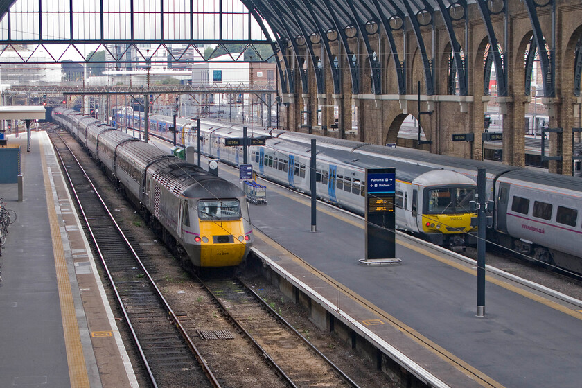 43296, GR 10.14 London King's Cross-Bounds Green ECS (5Y10) & 365523 FC 10.14 London King's Cross-Cambridge (1C14), London King's Cross station 
 Taken from the footbridge that spans the mainline platforms at King's Cross the magnificently restored station is seen from another angle. An East Coast HST set with 43296 at the rear (43312 is leading at the front about to enter Gasworks tunnel) is leaving working the 10.14 empty coaching stock run to Bounds Green. To the right and also leaving at exactly the same time is the 10,14 to Cambridge being worked by 365523 with a sister unit leading in the older First Group livery. 
 Keywords: 43296 10.14 London King's Cross-Bounds Green ECS 5Y10 365523 10.14 London King's Cross-Cambridge 1C14 London King's Cross station East Coast HST