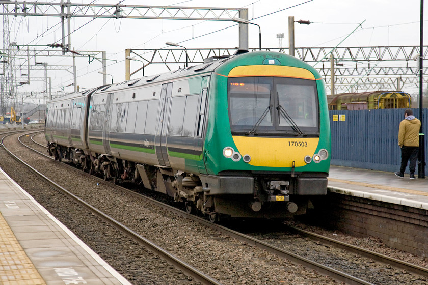 170503, LM 13.42 Birmingham New Street-Walsall (2A87), Bescot Stadium station 
 London Midland's 13.42 Birmingham New Street to Walsall 2A87 service arrives into Bescot Stadium station formed of 170503. Behind the fence on the platform is a stored shunter 08580 that looked very sorry for itself. 
 Keywords: 170503 13.42 Birmingham New Street-Walsall 2A87 Bescot Stadium station