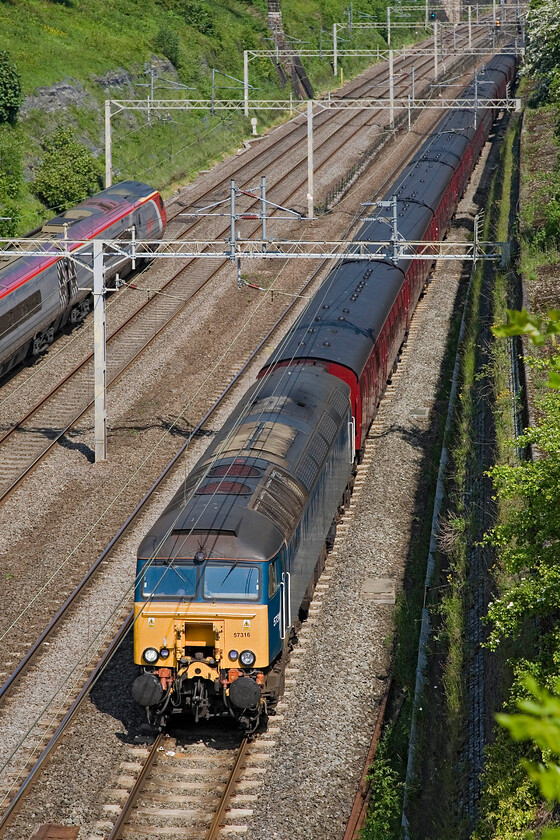 57316, outward leg of The CanterburyTales Express, 05.29 Skipton-Dover (1Z80), Roade cutting 
 Former Virgin Thunderbird 57304 (ex 'Gordon Tracy') passes through Roade cutting leading the outward leg of the 1Z80 Canterbury Tales charter. The charter left Skipton at the antisocial time of 05.29 and was heading for Dover with options to leave the train at Canterbury. A Virgin Pendolino heads northwards just to the left of the image. 
 Keywords: 57316 The CanterburyTales Express 05.29 Skipton-Dover 1Z80 Roade cutting