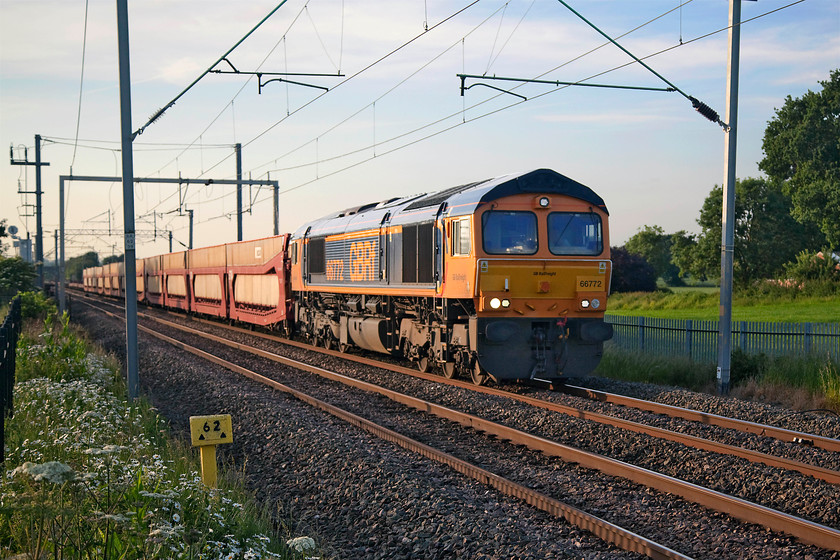 66772, 15.49 Garston-Dagenham Dock (6L48), MIlton Malsor 
 GBRF's 66772 looks very smart as it picks up speed from Northampton past Milton Malsor hauling the 15.49 Garston to Dagenham Dock empty cartics. The first few wagons are the covered types but they belie the fact that this was a very long train that took sometime to pass me as it was making pretty sedate progress! The light was now being spoilt by some high cloud drifting from the north west so I called it a day and headed home. 
 Keywords: 66772 15.49 Garston-Dagenham Dock 6L48 MIlton Malsor