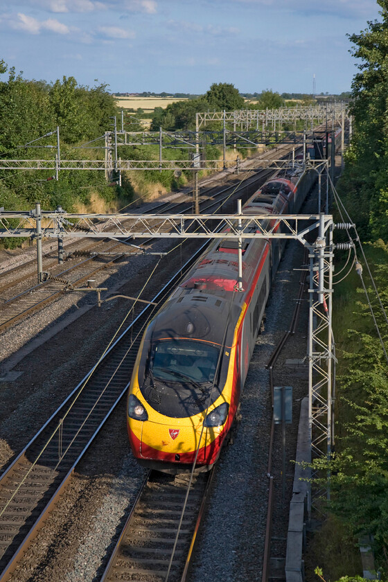 390124, VT 18.00 London Euston-Manchester Piccadilly (1H01), Victoria bridge 
 390124 'Virgin Venturer' takes the down fast line at speed between Roade and Ashton in rural Northamptonshire. The Pendolino is working the 1H01 Virgin 18.00 Euston to Manchester Piccadilly service. 
 Keywords: 390124 18.00 London Euston-Manchester Piccadilly 1H01 Victoria bridge Virgin West Coast Pendolino Virgin Venturer