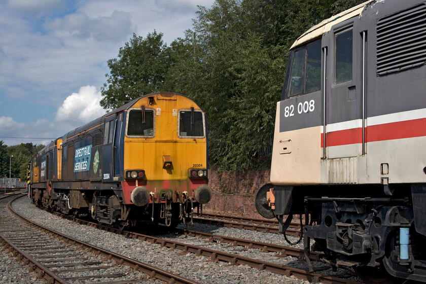 82008, 20304 & 20301, on display, Barrow Hill 
 With DRS having finally relived itself of its Class 20s after many years of use the curtain has finally come down on the use of these classic locomotives on the mainline. This has led to a surplus of locomotives with no home or use so until heritage lines take them on or they are prepared for possible use in the charter market then many are stored. 20304 and 20301 are seen facing an uncertain future at Barrow Hill along with long-term resident 82008. The last time that I photographed 20304 was in happier times back in 2014 when operating one of the infamous Buffer-Puffer charters, see.... https://www.ontheupfast.com/p/21936chg/29879244404/x20304-buffer-puffer-11-1-05-02-stafford 
 Keywords: 82008 20304 20301 on display Barrow Hill Roarer