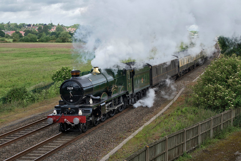 7029, outward leg of the Oxford 175 Express, 06.53 Solihull-Oxford (1Z65), Warkworth SP476394 
 7029 'Clun Castle' powers its way away from Banbury heading south with the Oxford 175 Express. This train left Solihull at 06.53 and was making the short trip to Oxford where it then led a round trip via London to celebrate the 175th anniversary of the railway arriving at Oxford. Unfortunately, the exhaust from 7029 has imposed somewhat on the photograph, I was hoping that it would have been a little more behind it as the wind was blowing from the south east, perhaps it was the effect of the M40 motorway embankment crossing the line that is behind me? 
 Keywords: 7029 Oxford 175 Express 06.53 Solihull-Oxford 1Z65 Warkworth SP476394