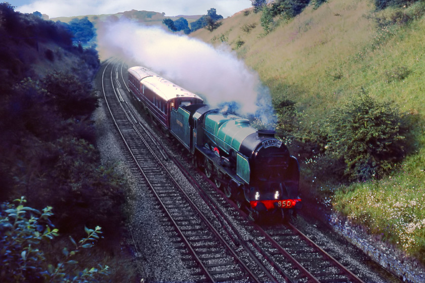 850 & Gresley support coaches, Skipton-Manchester Liverpool Road (for Great Railway Exposition), Nappa SD858536 
 In the pre-internet years, getting gen on moves and workings was a lot more hit and miss! Therefore, how we know about 850 'Lord Nelson' working from Skipton to Manchester Liverpool Road remains a mystery? It is seen here passing Nappa just south of Hellifield leading two Gresley Teak coaches; a relatively easy load. Earlier in the day, 850 had worked the outward leg of The Cumbrian Mountain Express from Carlisle to Skipton so finished its day operating this train that we had seen a number of times as it traversed the S & C. 
 Keywords: 850 Lord Nelson & Gresley support coaches, Skipton-Manchester Liverpool Road (for Great Railway Exposition), Nappa SD858536