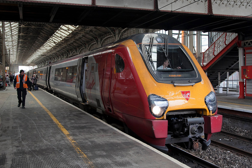 221143, VT 12.43 London Euston-Edinburgh W (9S70, 1E), Preston station 
 Virgin Trains 221143 'Auguste Picard' pauses at Preston station working the 9S70 12.43 London Euston to Edinburgh. Can somebody explain the economics of running a thirsty and noisy DMU on this journey of just under 500 miles completely under fully electrified 25kv wires? 
 Keywords: 221143 9S70 Preston station