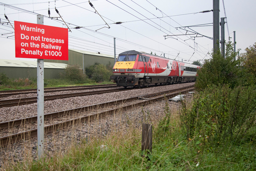 82201, GR 06.55 Skipton-London Kings Cross (1A13, RT), Biggleswade TL192433 
 DVT 82201 leads the 06.55 Skipton to King's Cross past Smarts foot crossing just south of Biggleswade. The signage is clear, but why on earth anybody would want to go anywhere near the track away from the foot crossing here with trains doing 125mph is beyond me! 
 Keywords: 82201 1A13 Biggleswade TL192433