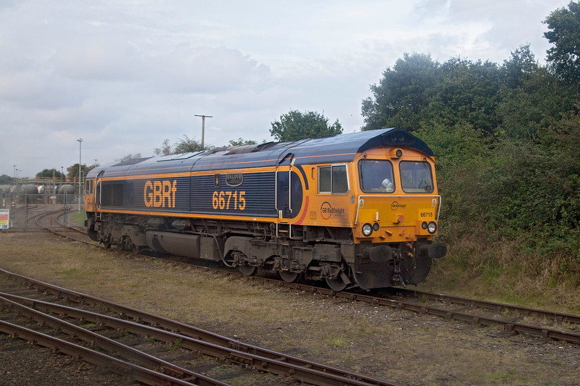 66715, stabled, North Walsham condensate terminal 
 Not the finest quality of picture, but a rare one! 66715 'Valour' stands just outside of the North Walsham gas condensate terminal. Stabilised hydrocarbon condensate is piped to its North Walsham depot from the Bacton gas terminal. It is stored in large tanks until it is removed once a day by a tanker train to Harwich for reprocessing. This return working is the only regular freight flow on the Sheringham branch line, even then only going as far as here at North Walsham. 
 Keywords: 66715 North Walsham condensate terminal