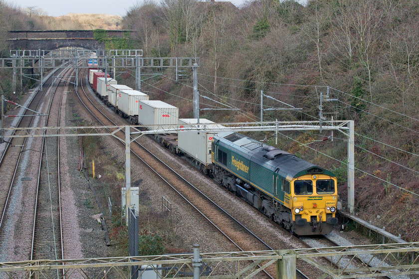 66541, 06.15 Trafford Park-Felixstowe North (4L97, 115L), Roade A508 road bridge 
 As I was crossing the A508 bridge in Roade on a shopping errand, it just so happened that the 4L97 06.15 Trafford Park to Felixstowe Freightliner was approaching. Just as it came into view some weak sunshine broke through the cloud and I managed a half reasonable photograph. 
 Keywords: 66541 06.15 Trafford Park-Felixstowe North 4L97 Roade A508 road bridge Freightliner