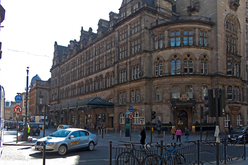 Frontage, Glasgow Central station 
 The imposing frontage of Glasgow Central station as it was rebuilt between 1901 and 1905 when the original station was deemed inadequate. The Caledonian Railway employed the renowned Scottish architect Robert Rowand Anderson to design the structure. The western end of the station is dominated by the Grand central Hotel that sits at the junction of Argyle Street and Oswald Street. With its fortunes having waxed and waned over the years, it is no firmly open for business for those who wish to experience its four star luxury. I took a photograph during my 1984 Railrover taken in the same position as this and, apart from the taxi being an Austin Ambassador rather than a VW Passat, very little has changed! 
 Keywords: Frontage, Glasgow Central station