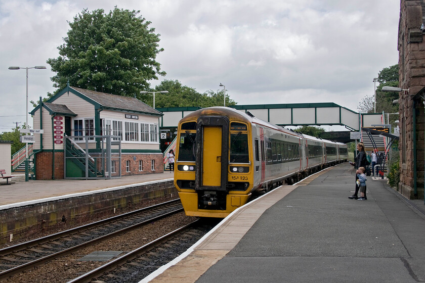 158823 & 158837, AW 08.30 Manchester Airport-Holyhead (1D33, 1E), Helsby station 
 My train back to Chester arrives at Helsby station. I travelled aboard 158823 and 158837 working the 08.30 Manchester Airport to Holyhead for about ten minutes enjoying the roomy ambience of these units. Despite being over twenty years old I find the travelling experience in the Class 158s far better than in many more modern trains. Notice Helsby Junction signal box on the opposite platform complete with some reproduction totems celebrating the station's best-kept status over a number of years. 
 Keywords: 158823 158837 08.30 Manchester Airport-Holyhead 1D33 Helsby station TfW Transport for Wales