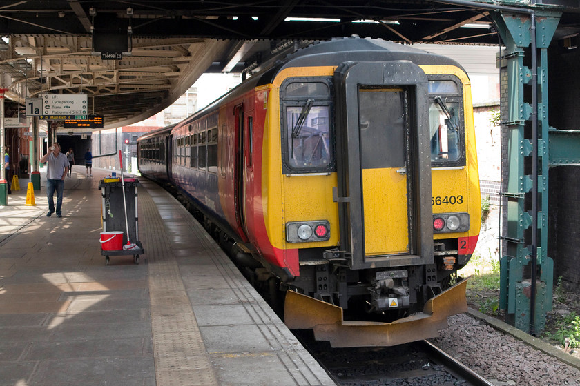 156403, EM 12.26 Nottingham-Worksop (2W12), Nottingham station 
 156403 waits at Nottingham's platform 1A to work the 12.26 to Worksop. This is the train that my boss (who is seen walking up the platform drinking a coffee) and I took as far as Kirby-in-Ashfield. This service follows the Robin Hood Line that reopened as a through route in 1998 following various states of closure and limited re-openings. 
 Keywords: 156403 12.26 Nottingham-Worksop 2W12 Nottingham station