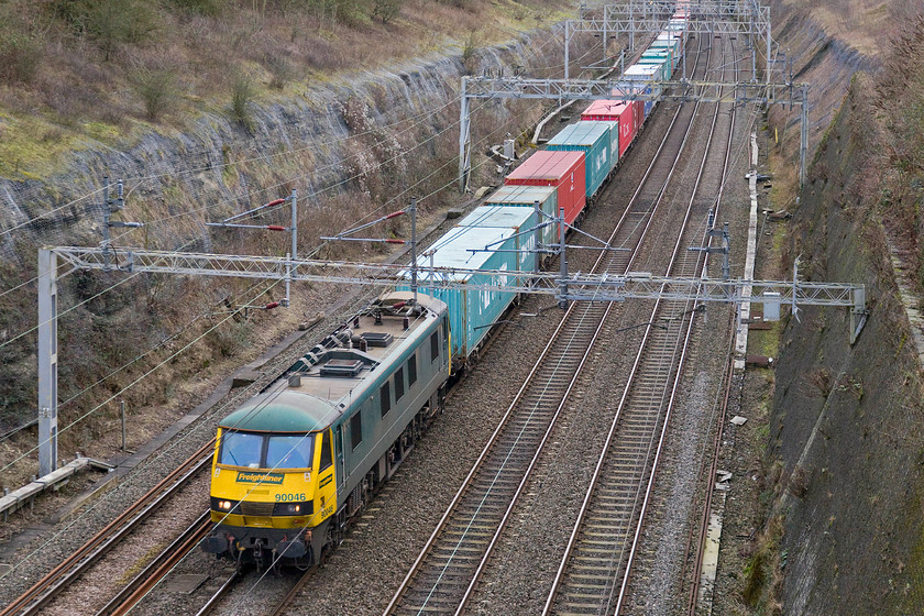 90046, 08.11 Felixstowe North-Crewe Basford Hall (4M93), Roade cutting 
 FREIGHT NUMBER ONE - 90046 leads the 4M93 Felixstowe to Crewe Freightliner northbound through Roade cutting. As a result of considerable work two years ago the flanks of the cutting were cleared and stabilised with wire netting. The saplings are already taking over again as nature reverts the cleared area to type. 
 Keywords: 90046 08.11 Felixstowe North-Crewe Basford Hall 4M93 Roade cutting Freightliner