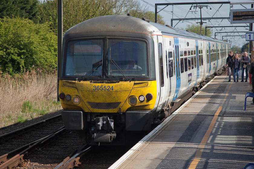 365524, GN 10.08 Ely-London Kings Cross (1T57, 5L), Waterbeach station 
 Despite the sun being out, the passengers waiting for the 10.08 Ely to London King's Cross service at Waterbeach station tell a different story with their winter coats still being worn. 365524 arrives into the station forming this Great Northern working. Waterbeach station is 63 miles from King's Cross but this is likely to change (slightly) as there are plans afoot to close this station and move it to a new location to better serve a huge new town on the site of the old Waterbeach Barracks a short distance to the north. This may also alleviate the huge parking problems at the present station. 
 Keywords: 365524 1T57 Waterbeach station