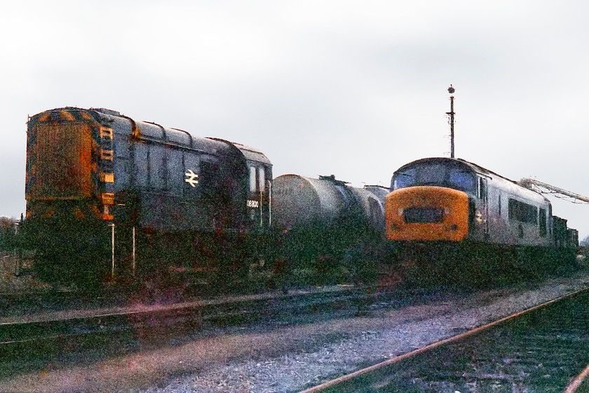 08800 & 46020, fueling point, Westbury MPD 
 At the back of Westbury depot was the fuelling point. Along with some fixed tanks there were also these tankers that were delivered periodically. Here at the fuelling point is one of Westbury's resident shunters, 08800, next to it is 46020. This class 08's claim to fame is that it was modelled by Bachmann in Inter City swallow livery and can still be bought and driven today, but in OO gauge only! 
 Keywords: 8800 46020 Westbury MPD