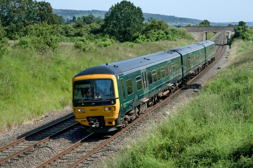 166217, GW 12.27 Southampton Central-Great Malvern (2M98, 1L), Croome Perry Wood SO900459 
 Croome is a lovely and very popular spot within the railway fraternity a short distance south of Abbotswood Junction. Pictures can be taken from the road bridge seen in the background or from the occupation bridge that I am standing on. However, in order to get to the latter, a short walk through Croome Perry Wood is required and the passing of a gate with a 'Do not trespass' sign firmly attached! 166217, having been cascaded from the London area, is working the 12.27 Southampton Central to Great Malvern service. Previous to this, the service would have been operated by a class 15X unit, the Turbo is a small upgrade but one that does still not provide passengers with air conditioning. 
 Keywords: 166217 12.27 Southampton Central-Great Malvern 2M98 Croome Perry Wood SO900459