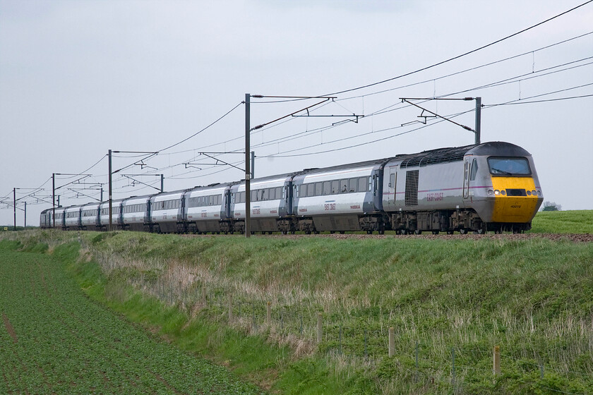 43272, GR 13.00 Edinburgh Waverley-London King's Cross (1E16), Frinkley Lane crossing SK906436 
 The HSTs have been synonymous with services on the East Coast Mainline since 1977 outlasting the reign of the Deltics by many years! As 43072 this particular power car, now numbered 43272, has been in operation on the line all of its working career being introduced as part of set 254011. I wonder if anybody has any details on the mileages that this power car (and the others for that matter) has clocked up, it will be an extraordinary figure I have no doubt! Adding another three hundred and ninety-three miles to its tally, the HST passes Frinkley Lane on the approach to Granthan working the 13.00 Edinburgh to King's Cross service. 
 Keywords: 43272 13.00 Edinburgh Waverley-London King's Cross 1E16 Frinkley Lane crossing SK906436 InterCity East Coast HST