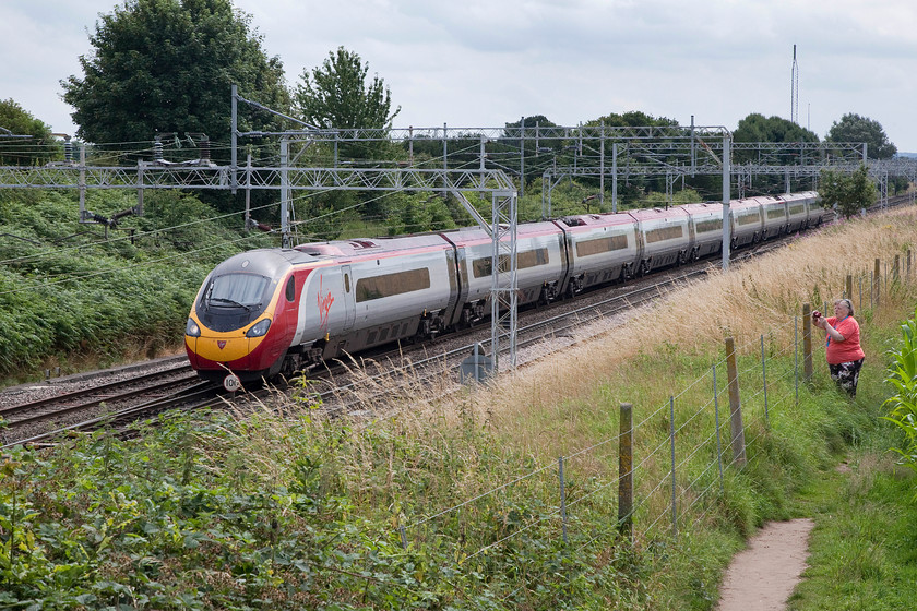 390045, VT 11.40 London Euston-Manchester Piccadilly (1H66), Casey bridge, Basford Hall Junction 
 A fellow enthusiast gets her shot of 390045 as it approaches Casey bridge just south of Basford hall Junction. After the frenetic activities at Gresty Bridge open day with hundreds of enthusiasts vying for a spot to get their pictures, the relative peace at Casey bridge was relaxing! 
 Keywords: 390045 11.40 London Euston-Manchester Piccadilly 1H66 Casey bridge Basford Hall Junction