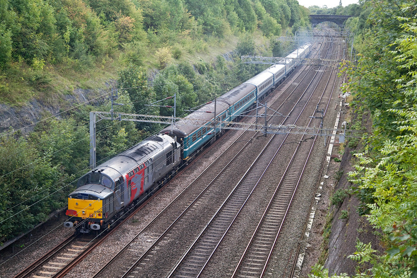 37884 & 37611, outward leg of The Greendale Rocket, 06.40 Burton-on-Trent-Willesden (1Z37), Roade Cutting 
 With a nice rake of Riviera Trains Mk.II stock The Greendale Rocket railtour passes through Roade Cutting. It started at Burton-on-Trent and took in various rare track in theMidlands and London area. In this image, 37884 brings up the rear of the railtour with 37611 in the distance at the front. 
 Keywords: 37884 37611 The Greendale Rocket 06.40 Burton-on-Trent-Willesden 1Z37 Roade Cutting