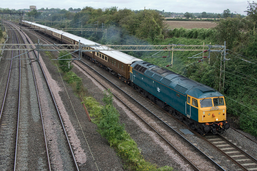 47614, outward leg of the Royal Windsor Statesman, 06.23 Preston-Windsor & Eton Riverside (1Z85), Victoria bridge 
 Resplendent in its BR blue paint, 47614 leads the outward leg of the Royal Windsor railtour past Victoria bridge between Northampton and Milton Keynes. The railtour started out from Preston at 06.23 and ran to Windsor and Eton Riverside as 1Z85. The stock is a smart set of Mk. II coaches with the odd Mk. I printed in a non-authentic version of chocolate and cream with white roofs. This particular class 47, as D1733, was chosen by British Railways (soon to become BR) to wear the experimental XP64 turquoise-blue livery appearing from Derby works on 16th April 1964. This livery then morphed into the one we all know and the one it seen wearing here with the addition of a small Scottie dog. 
 Keywords: 47614 Royal Windsor Statesman 06.23 Preston-Windsor & Eton Riverside 1Z85 Victoria bridge