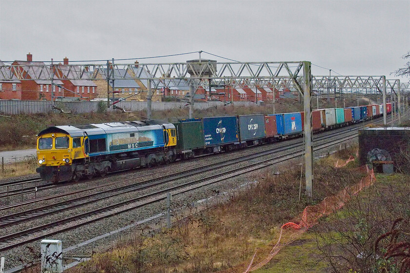 66709, 10.36 Felixstowe North-Trafford Park (4M22, 12E), site of Roade station 
 In deteriorating light and wearing its one-off Medite Shipping Company (MSC) livery 66709 'Sorrento' passes Roade leading the fully loaded 4M22 10.36 Felixstowe to Trafford Park GBRf operated Freightliner service. It is unclear from this angle but the graphic on the flank of the 66 is a side-on view of a fully loaded contained ship, a livery that the locomotive has worn since 2012. 
 Keywords: 66709 10.36 Felixstowe North-Trafford Park 4M22 site of Roade station Sorrento