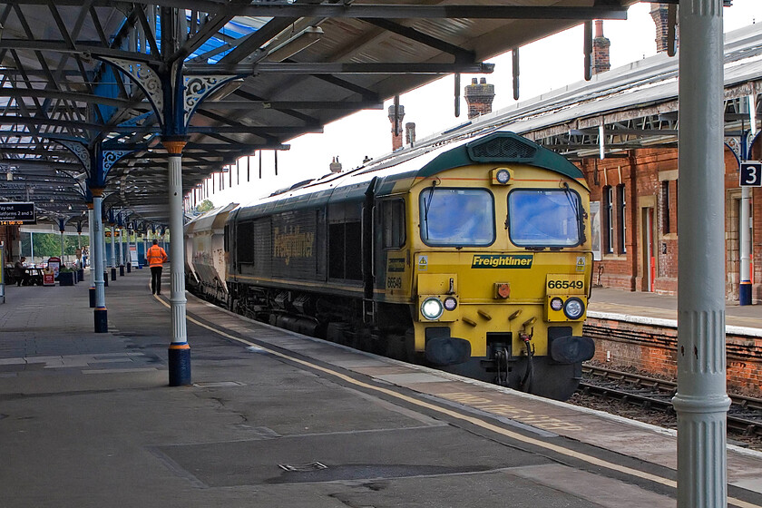 66549, 12.45 Theale Lafarge-Wool Sidings (6O49), Salisbury station 
 I was pleased to capture this relatively new freight flow at Salisbury. The 6O49 Theale Lafarge to Wool sidings conveys empty HIA ninety-tone aggregate wagons to collect sand to be then taken back to Theale. With some very rusty window surrounds (a common Class 66 malaise) 66549 brings the train into Salisbury for a crew change. 
 Keywords: 66549 12.45 Theale Lafarge-Wool Sidings 6O49 Salisbury station Freightliner sand train